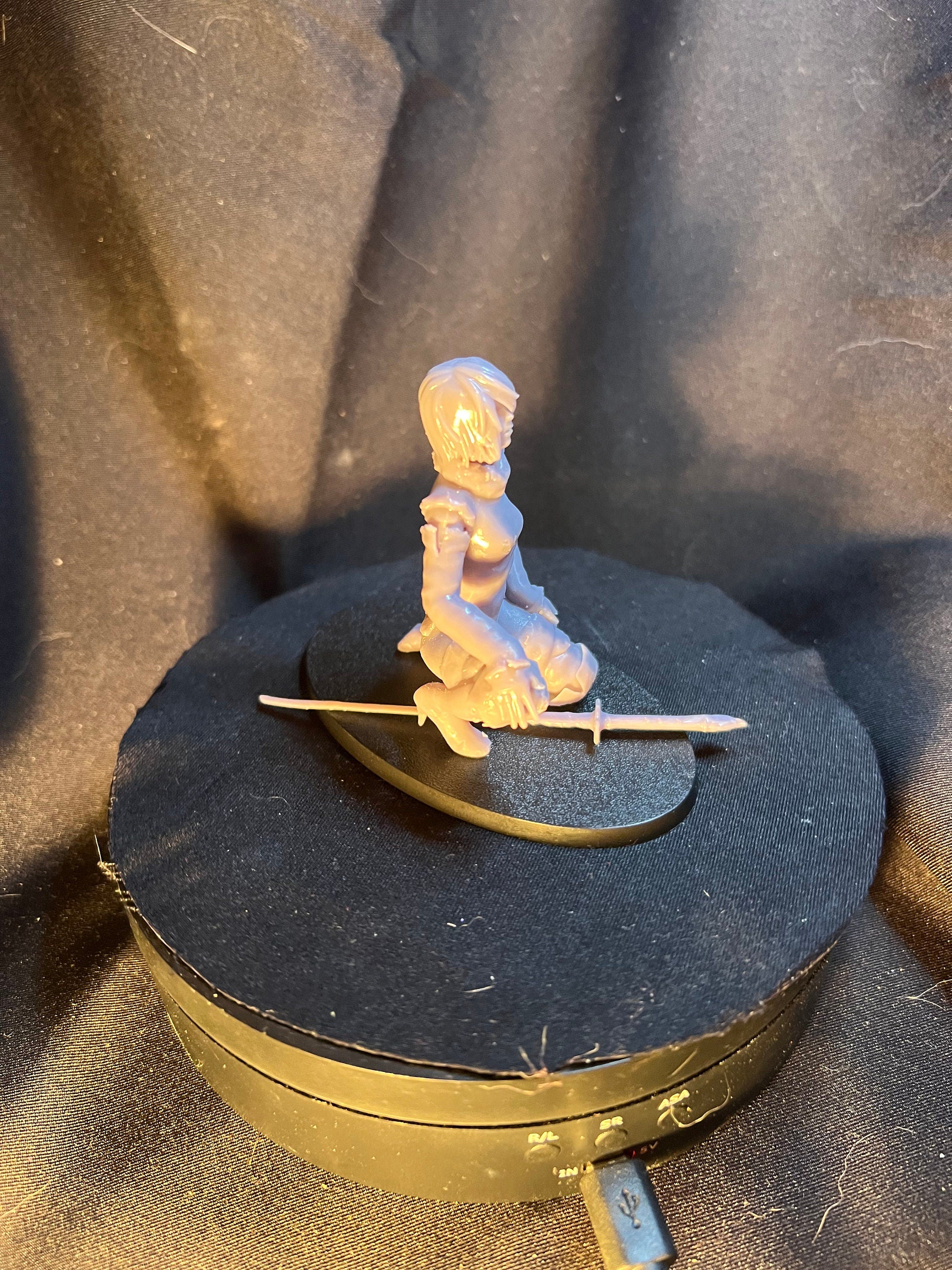 Kneeling Woman Warrior with a Sword